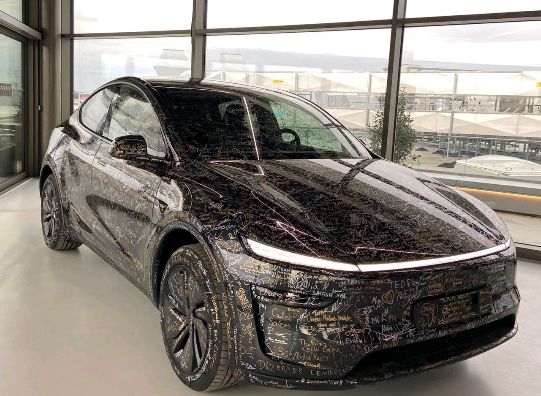 Employees signing the Model Y